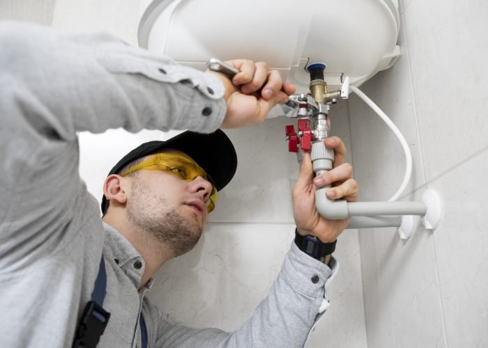 worker-repairing-water-heater (1) worker-repairing-water-heater (1)